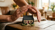 © sumi yati - Hands Protecting Small Model House.