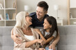 © fizkes - Loving man cuddling older mom and his cute little daughter, congratulate beloved females with Happy Women Day, smile, looking at each other with love, enjoy warm, tender moments together at home. Ties