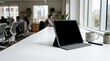 © Your Stocks  - Sleek laptop on a modern office desk with blurred team meeting background natural light and professional workspace essentials
