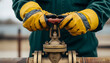 © Mahmuda - industrial worker turning valve wheel|oil and gas pipeline maintenance|heavy duty leather work gloves|plumber operating industrial pipe valve|shut off water or gas supply