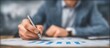 © Generative AI - Close up of a professional analyzing financial charts and graphs with a pen in hand