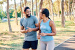 © Lumos sp - Smiling active mature mid aged couple jogging exercising and having fun and laughing together taking a break in the park