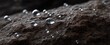 © ckybe - Water droplets gradually penetrate the porous rock surface in nature.