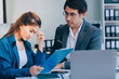 © ARMMY PICCA - Millennial Asian stressed depressed worried thoughtful professional male businessman female businesswoman employee staff in formal business suit sitting thinking solving problem ideas in office room