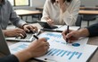 © YiuCheung - Business team reviews charts calculates data with laptop and
