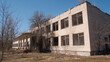 © bisonov - Deserted School Facade With Broken Windows, Peeling Plaster And Empty Classrooms Visible Through Glass,