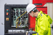 © BESTIMAGE - Automation Engineer Inspecting Control Panel in Industrial Factory Male Engineer Checking Electrical Wiring and Robot Control System Engineer with Hard Hat and Gloves Working on Control Panel