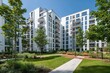 © Rasyid - Modern Apartment Buildings with Lush Green Courtyard and Trees.