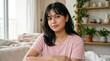 © TheMorphicArchive - Young Indian woman sitting at home with natural light, calm expression lifestyle portrait