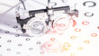 © Антон Скрипачев - Eye exam equipment rests on a vision chart. Circles vary in size and color across the chart. Medical tools show precise optical measurements. No people are present. Ideal for healthcare, vision