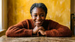 © Visual Oasis - Portrait of confident young woman with braided hair smiling at camera indoors