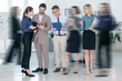 © New Africa - Happy coworkers indoors, motion blur effect. Busy office life