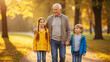 © Lavaz Kopi - Happy Grandfather Walking with Grandchildren in a Beautiful Autumn Park.