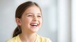 © dwi - Joyful young girl with a bright smile and ponytail.