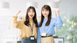© Trickster* - ガッツポーズで喜ぶ同僚の日本人女性・ビジネスウーマンのビジネス成功イメージ, Japanese Businesswomen Colleagues Celebrating Success with Fist Pump