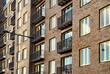 © a40757se - Narrow and airy balconies of a brick building