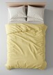 © Ryzhkov - Single bed with pale yellow duvet and white pillows on a grey floor from a top down view for a home interior bedding catalog with copy space
