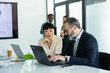 © Dejan - Diverse professionals working together in a modern office, planning strategies and discussing project data during a corporate meeting