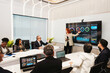© artitwpd - Professionals in a modern conference room review data dashboards on a large screen as a presenter leads a strategy meeting.