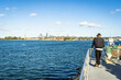 © red.io - Passenger Standing on Sydney Harbour Ferry with City Skyline and Blue Water in Australia