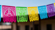 © Lexi - Colorful papel picado banners hanging against clear sky background
