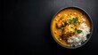 © LimeSky - Chicken curry and rice in a bowl on a dark backdrop. Indian and Thai cuisine. Panang curry with coconut milk. Aerial view, room for text. Restaurant food photography.