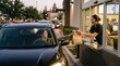 © Niko - Woman in car receiving fast food order at drive-thru