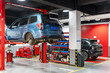© zhouyilu - Automotive Repair Shop with Two Cars on Lifts