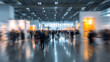 © CStock - A busy exhibition hall with blurred attendees admiring various exhibits and displays, creating a vibrant atmosphere.