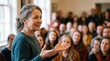 © AlfaSmart - Middle aged woman speaking to a crowd of people in a church hall. Community gathering or religious lesson. Inspirational speaker sharing message about Jesus Christ and faith.
