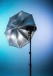 © Katherina - Studio photography silver umbrella reflector equipment setup on a light stand, highlighting texture and professional lighting accessory, portable, reflector, illumination