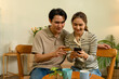 © MIND AND I - Couple Using Smartphone and Credit Card for Online Shopping