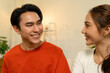 © MIND AND I - Close-Up of Happy Young Asian Couple Smiling and Looking at Each Other