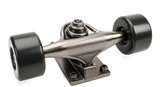 A close-up of a skateboard truck with black wheels