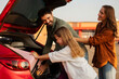 © Home-stock - Family with child girl preparing for road trip, loading their car with luggage and chatting