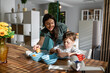© Zoran Jesic - Mother and child enjoying family breakfast together in morning sun