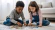 © kodidesign - Diverse children playing with a jigsaw puzzle on the floor. Black boy and Caucasian girl solving a puzzle together at home. Early childhood education and teamwork concept