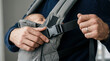 © ArtFocus Studio - Close-up of a modern father adjusting the buckle of an ergonomic baby carrier while carrying his sleeping newborn, focusing on active caregiving and safety.