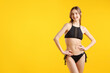 © New Africa - Beautiful woman wearing stylish swimsuit on yellow background. Space for text