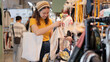 © ChayTee - Young teen tourist Gen Z asia female choose look at zero waste eco go green buy heap second hand sale store flea market thrift old used vintage fabric style. Happy woman asian people small retail shop