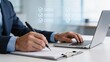 © Infinite Views - Businessman writing report on clipboard while working on laptop with digital checklist overlay modern office workflow corporate productivity task management professional