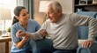 © Chenda - A smiling caregiver assists an elderly man sitting in an armchair. The woman, with long dark hair pulled back,