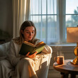 © mdmubarok - Cozy Woman Reading Book by Window with Coffee in Warm Natural Light at Home