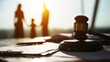 © Bonsales - Gavel on legal documents with a blurred family silhouette in the background, symbolizing family law, divorce, and legal support