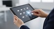 © Shazzad - Professional using a digital tablet for business applications in an office setting
