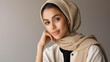 © Kateryna Arkhypova - Studio portrait of a confident woman in a modern hijab against a neutral background, diversity and cultural marketing concept, fashion and beauty, Muslim identity representation,
