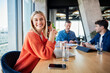 © BusinessClass by W61 - Smiling businesswoman sitting with colleagues in office