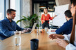 © BusinessClass by W61 - Smiling businesswoman discussing over pie chart with colleagues