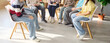 © Studio Romantic - Teens students in therapy session with counselor. In a bright school library, a circle shares experiences and builds empathy in a guided group discussion. Youth mental health peer support.