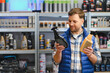 © Serhii - Man comparing car care spray products in store